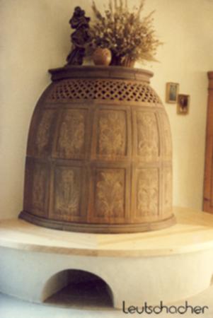 Bei diesem Kachelofen, der von der Firma Pauker in Penzberg mit Ofenkacheln von Leutschacher gebaut wurde, handelt es sich um einen traditionellen Ofen in Bienenkorbform